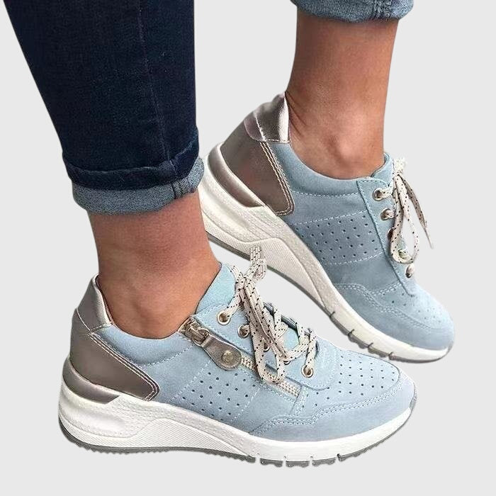 A woman on a walk wearing soft, supportive sneakers on a bright day.
