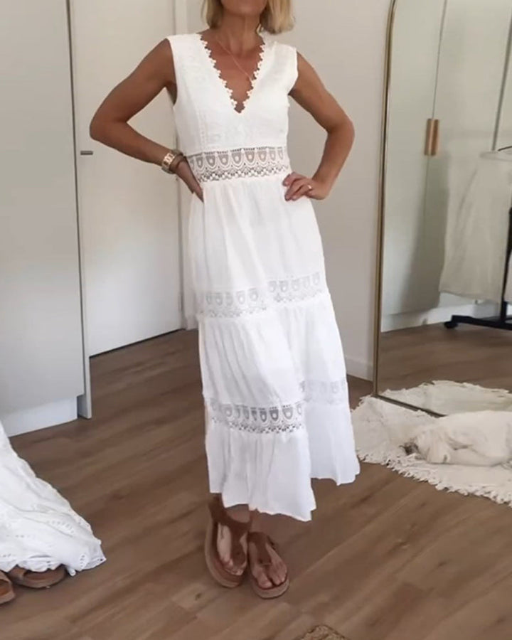 Woman wearing the April™ camisole maxi dress with delicate detailing and a flowing skirt at a summer gathering.