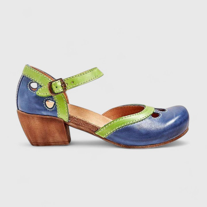 A woman in blue and green retro block heel shoes at a summer garden party.