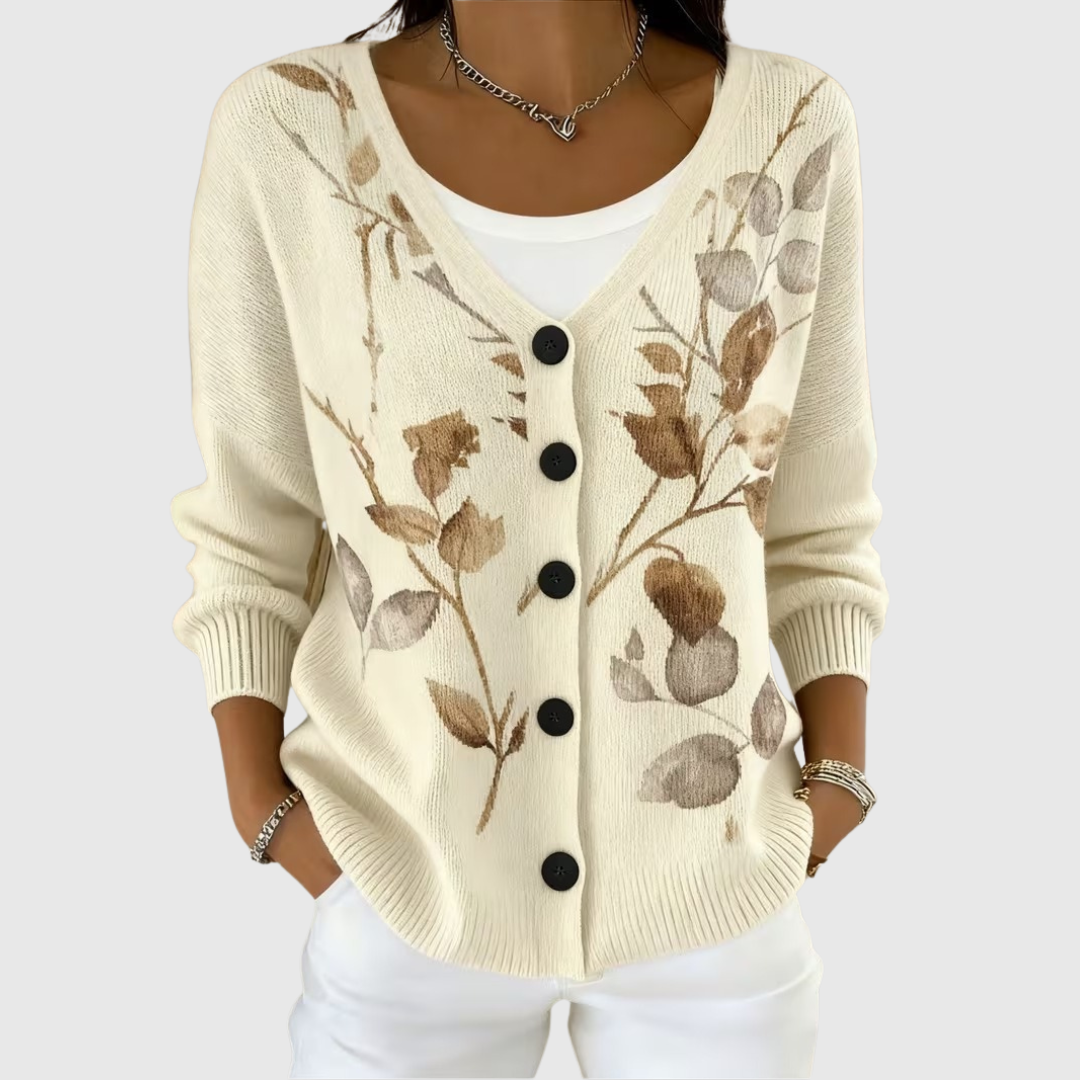 A woman wearing a soft all-year button cardigan open over a top, relaxed and neat