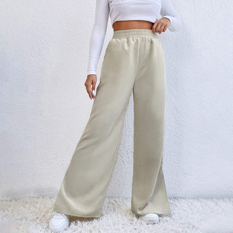 Woman wearing wide-leg ribbed joggers with a fitted top, relaxed at home.