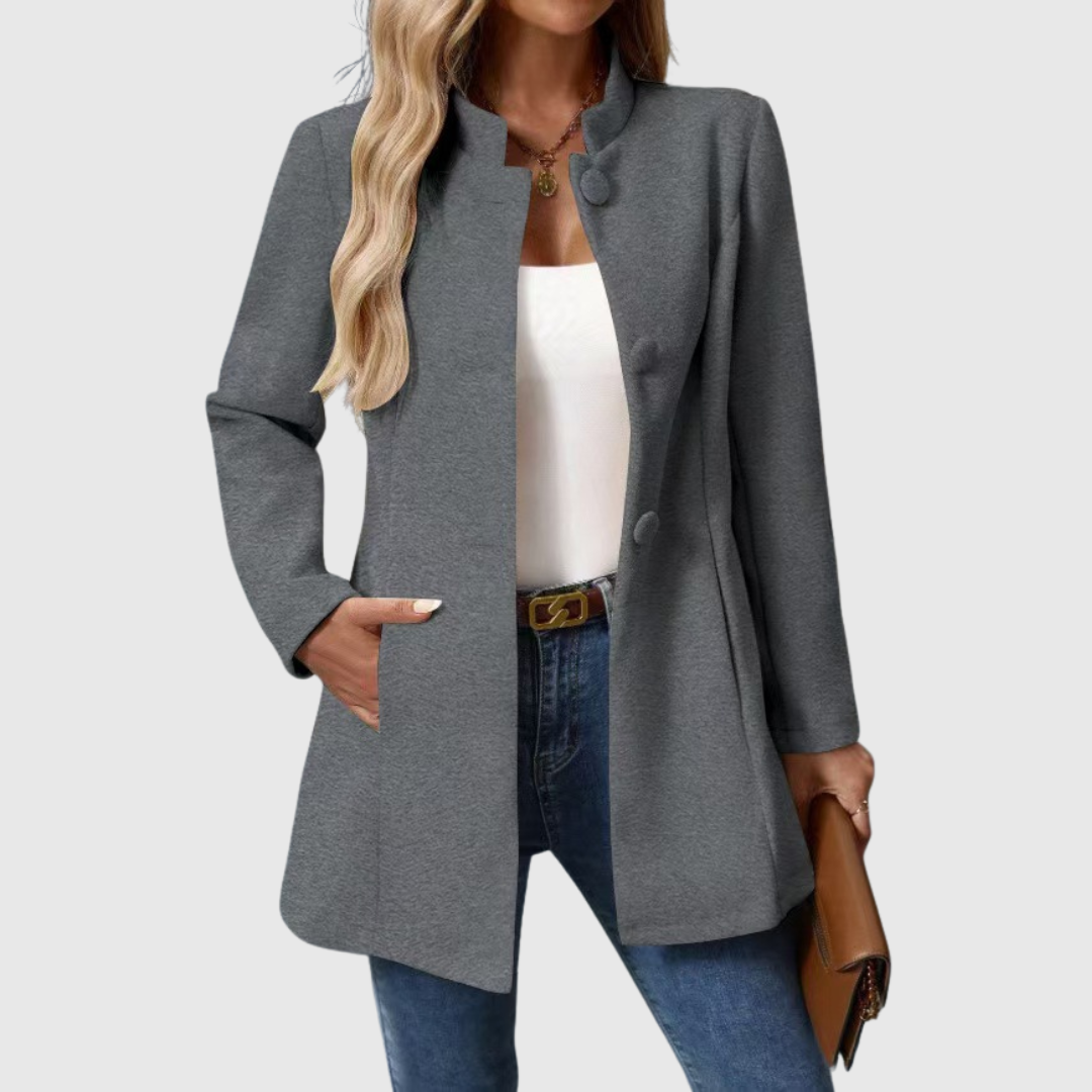 A woman wearing a tailored jacket with a neat stand collar and a button front
