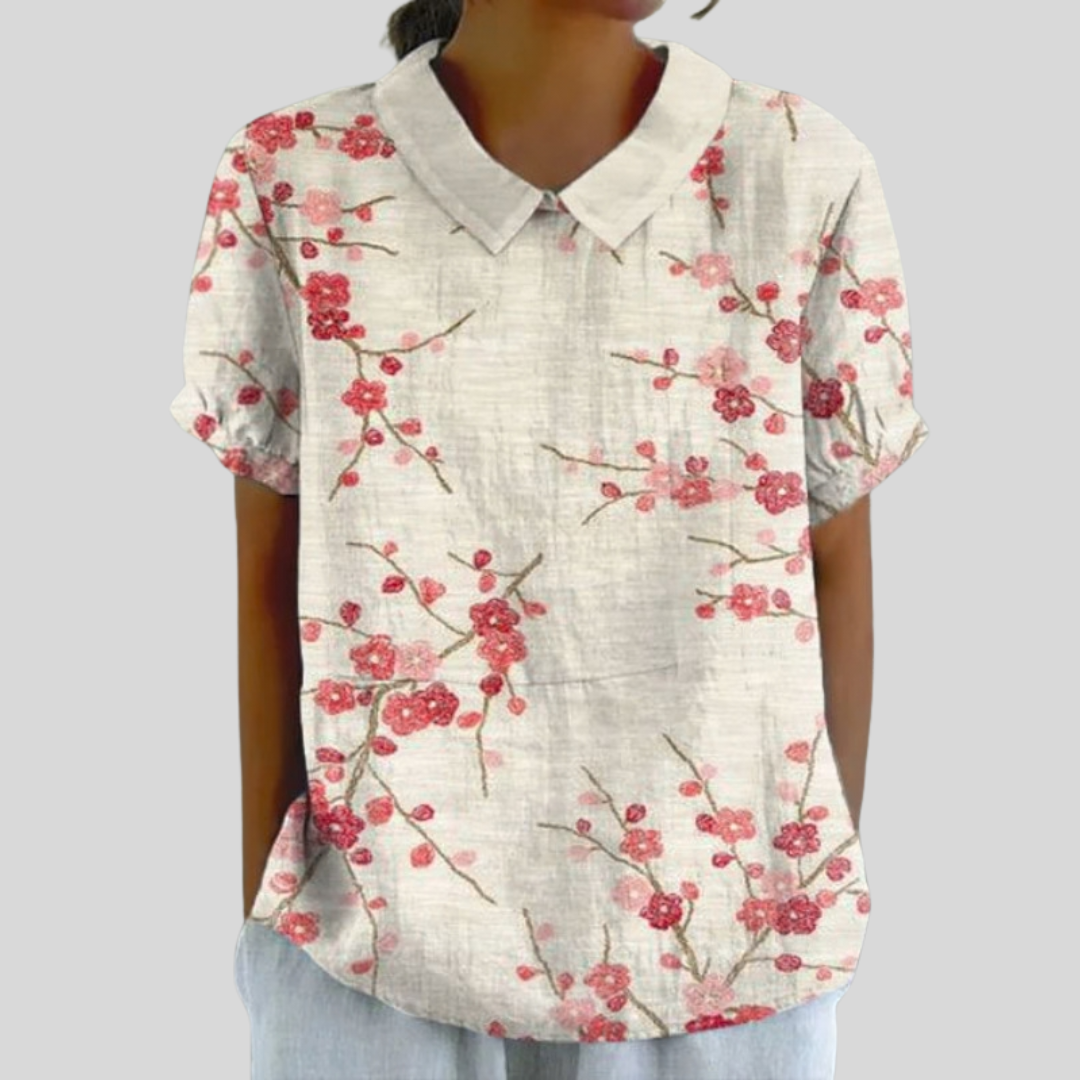 A woman wearing a floral top with a polo collar for a relaxed day