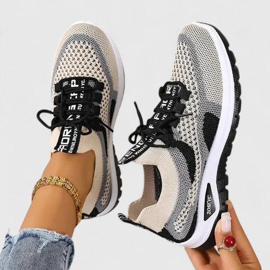 A woman lacing up light, breathable orthopaedic sneakers before a walk.
