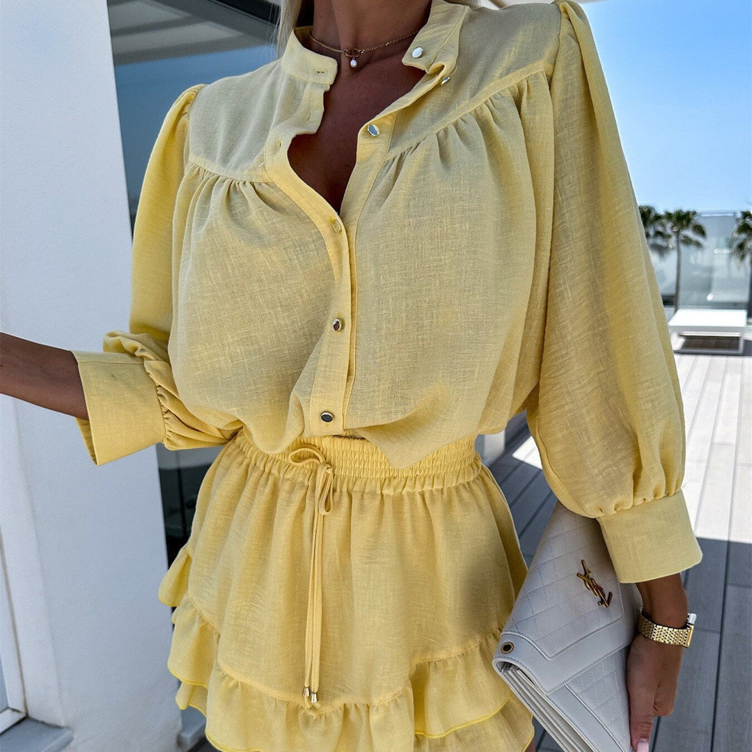 A woman wearing a white buttoned top with ruffled shorts