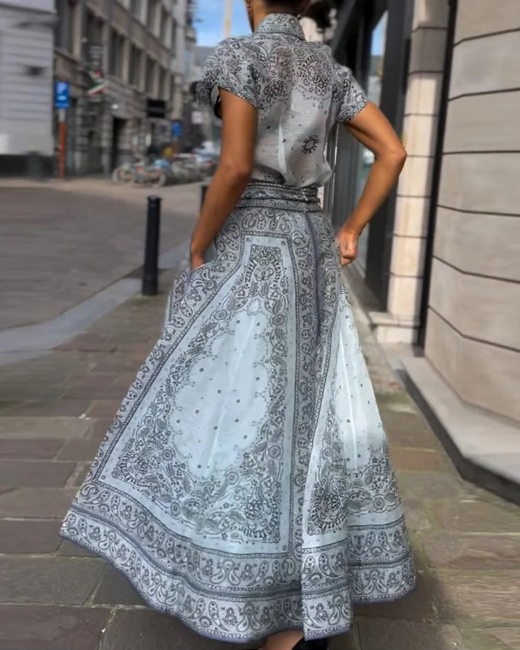 A woman wearing a boho-print top with a flowing midi skirt