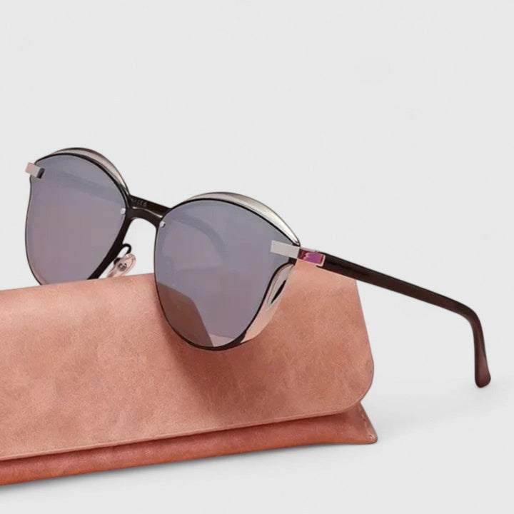 A woman wearing minimalist polarised gradient sunglasses on a bright day.