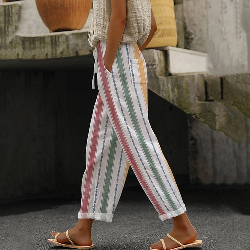 A woman wearing colourful vertical-striped casual pants with a straight leg and elastic waist.
