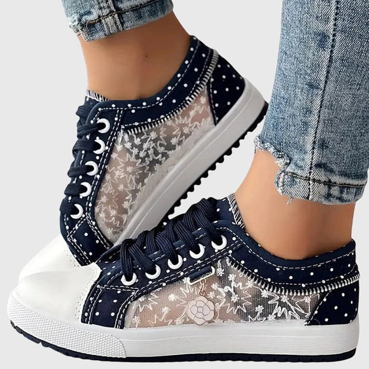 A woman walking comfortably in blue cushioned orthopaedic sneakers