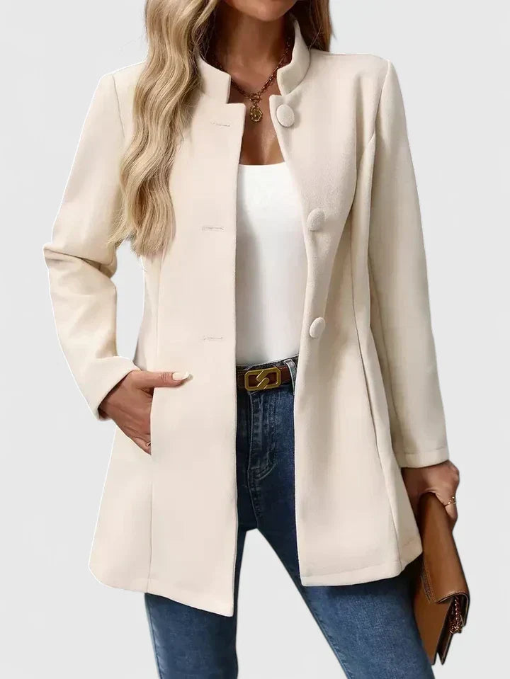 A woman wearing a tailored jacket with a neat stand collar and a button front
