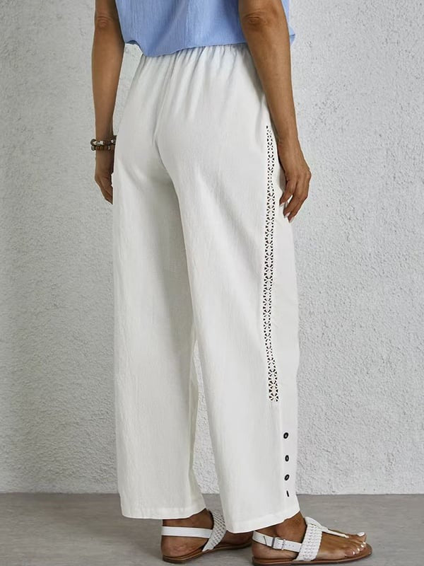 Woman wearing relaxed button-detail pants with a simple top, out for the day.