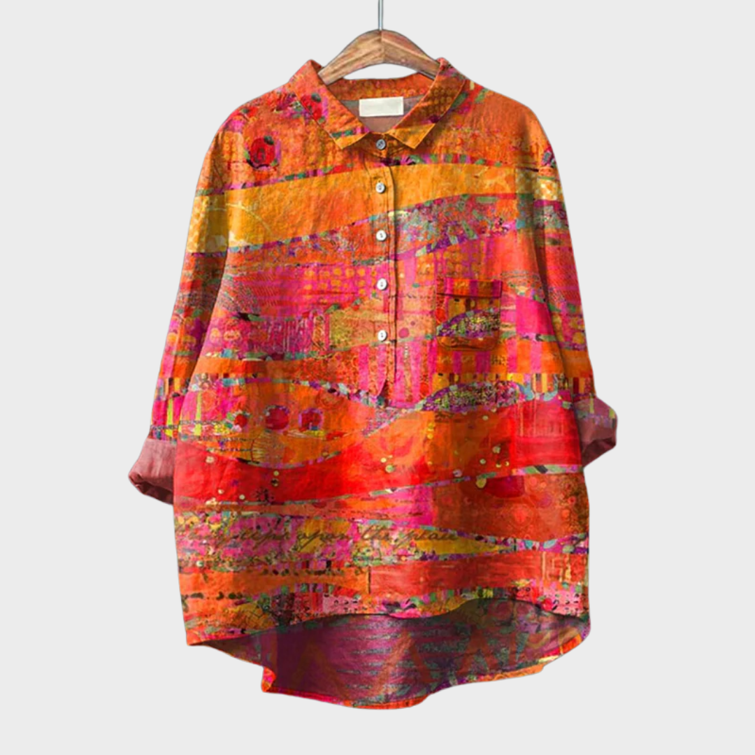 Woman wearing an orange printed summer blouse with a soft, flattering silhouette.