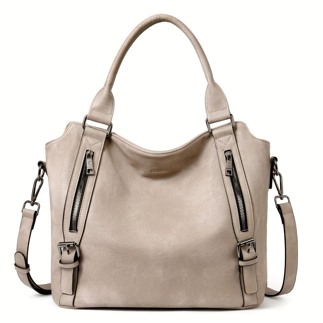 A woman wearing a roomy shoulder bag across her body while out running errands.