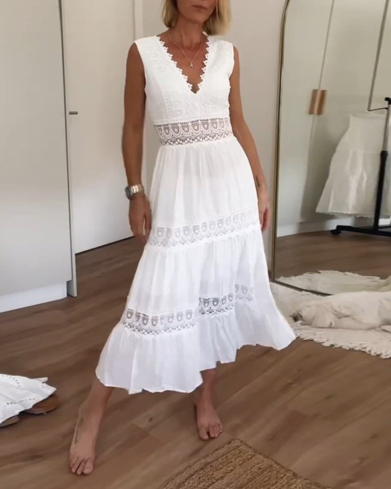 Woman wearing the April™ camisole maxi dress with delicate detailing and a flowing skirt at a summer gathering.