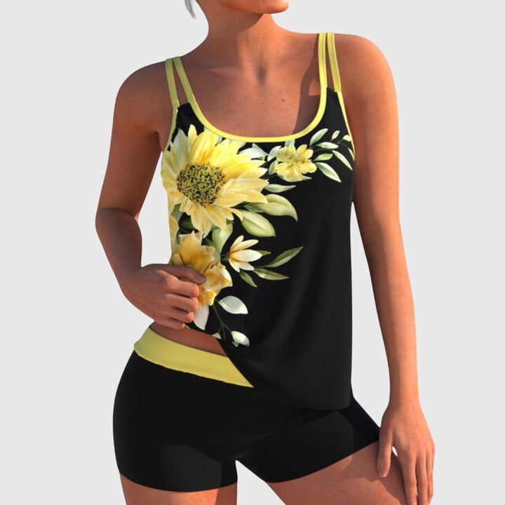 A woman by the water in a fresh printed two-piece swimsuit, relaxed and confident in the sun.