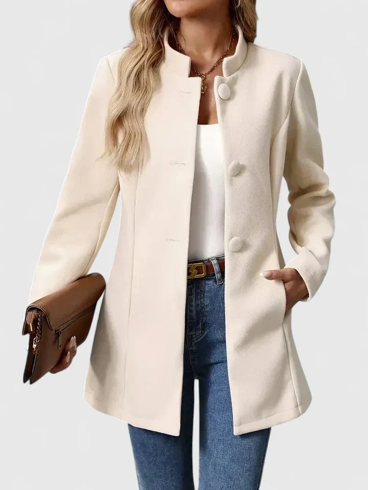 A woman wearing a tailored jacket with a neat stand collar and a button front