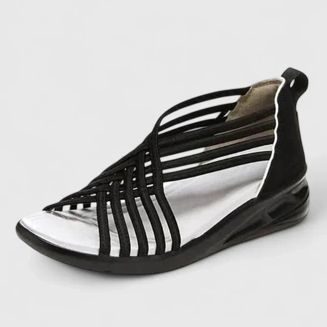 A woman walking with ease in elegant wide-fit everyday sandals with a cushioned footbed.
