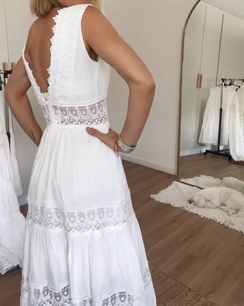 Woman wearing the April™ camisole maxi dress with delicate detailing and a flowing skirt at a summer gathering.