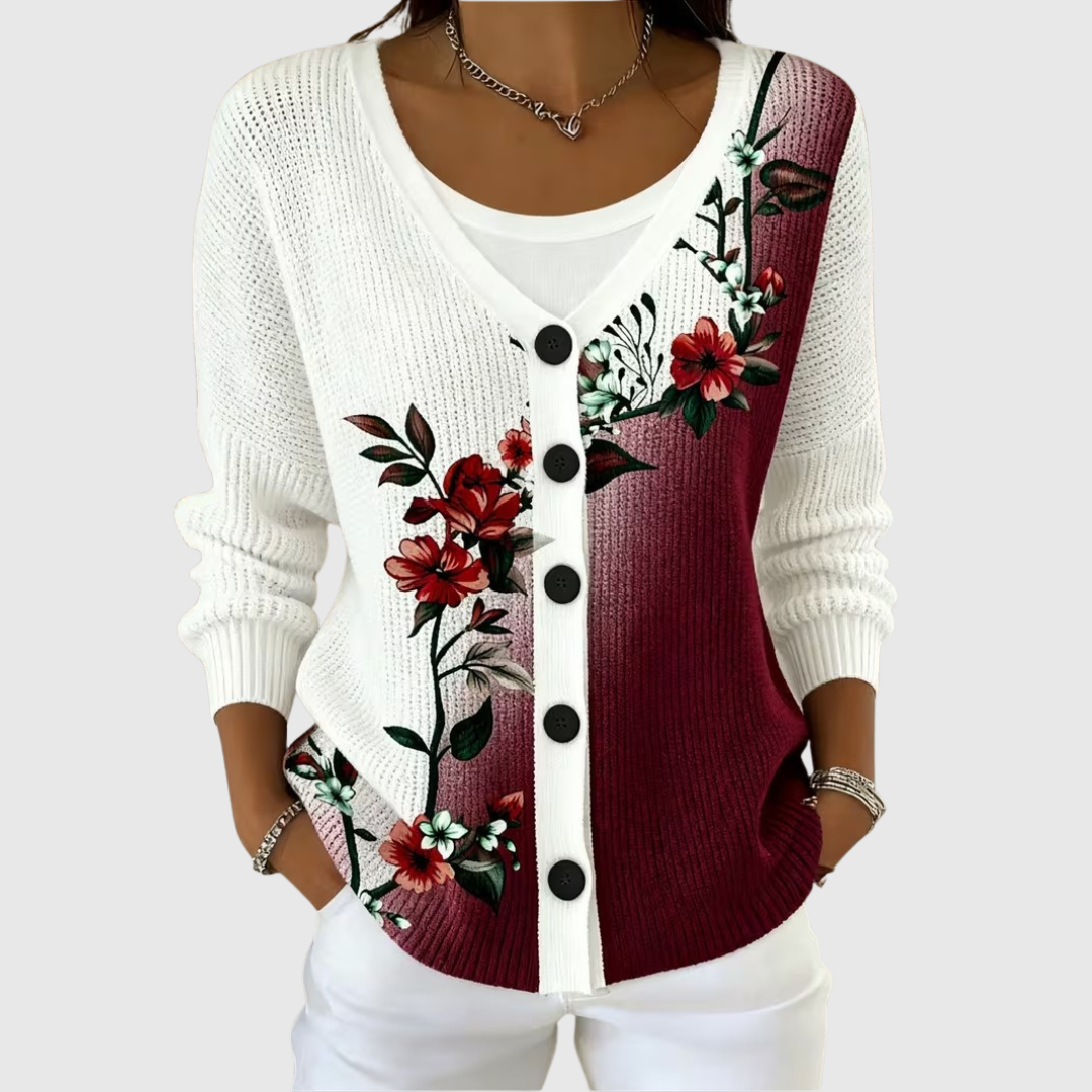 A woman wearing a cream and burgundy colour-block cardigan with a red floral print and black buttons.