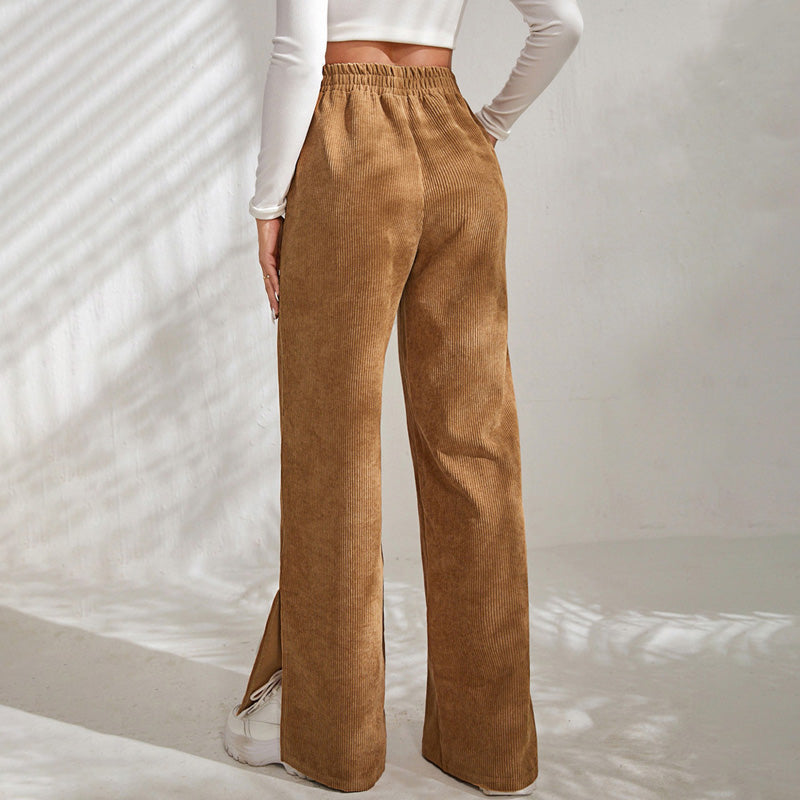 Woman wearing wide-leg ribbed joggers with a fitted top, relaxed at home.