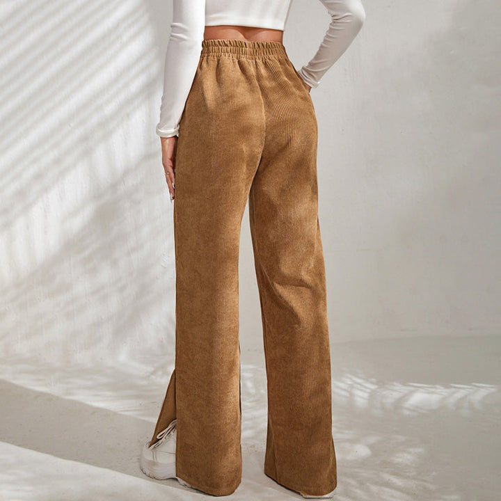 Woman wearing wide-leg ribbed joggers with a fitted top, relaxed at home.