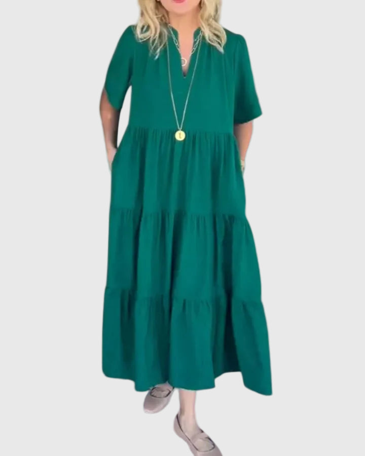 Woman wearing the Karen maxi dress with her hands resting in its side pockets.