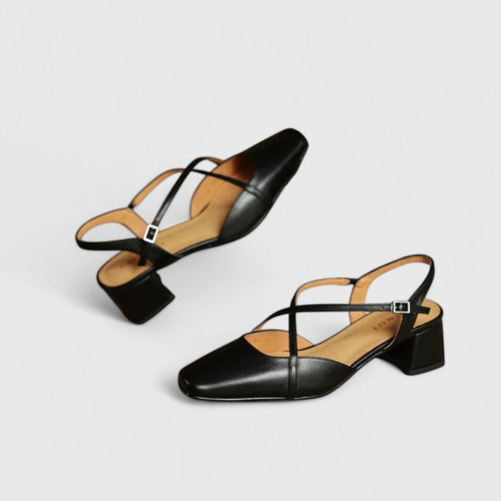 Burgundy closed square-toe flats with criss-cross instep straps and a buckled slingback.