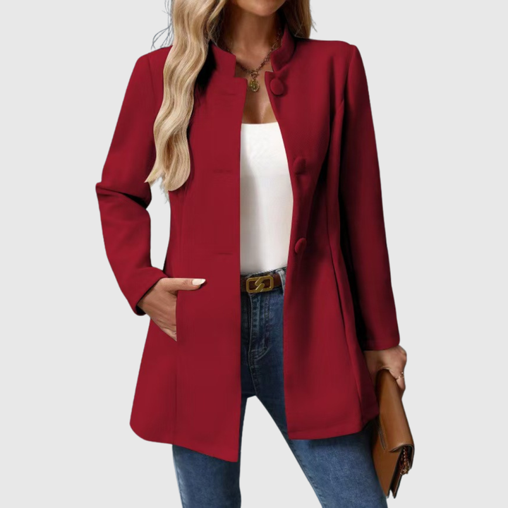 A woman wearing a tailored jacket with a neat stand collar and a button front
