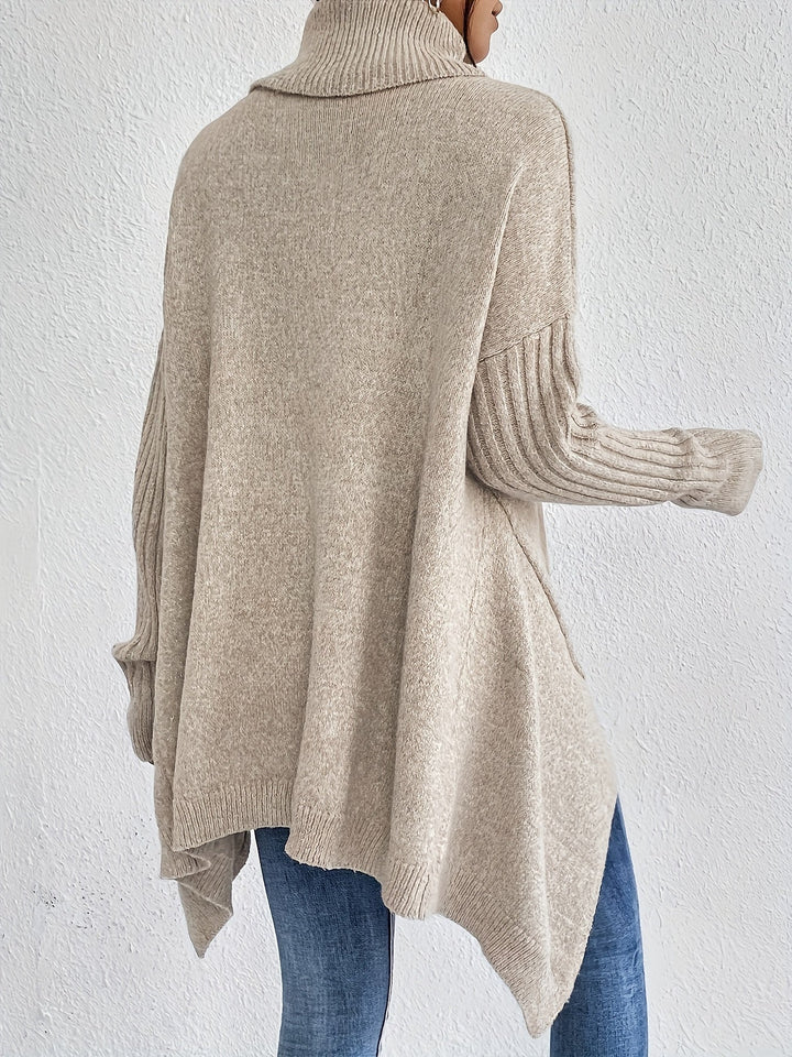 A woman wearing a stand-collar sweater with a chic asymmetric drape, warm and polished.