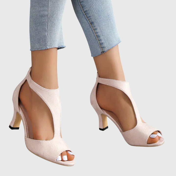 A woman in soft pink supportive heels walking with ease through her day.