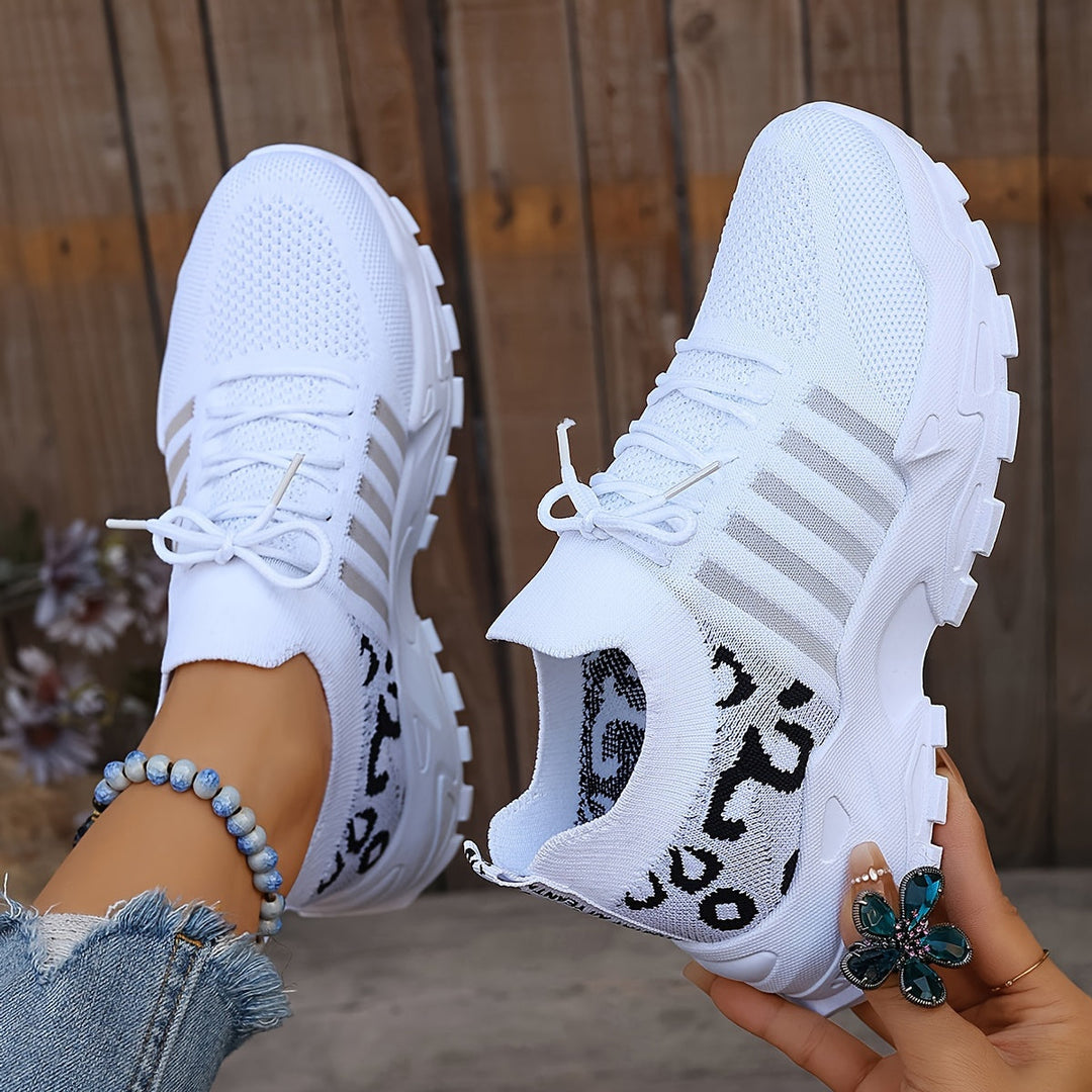 A woman walking in light, breathable comfort sneakers on a warm day.