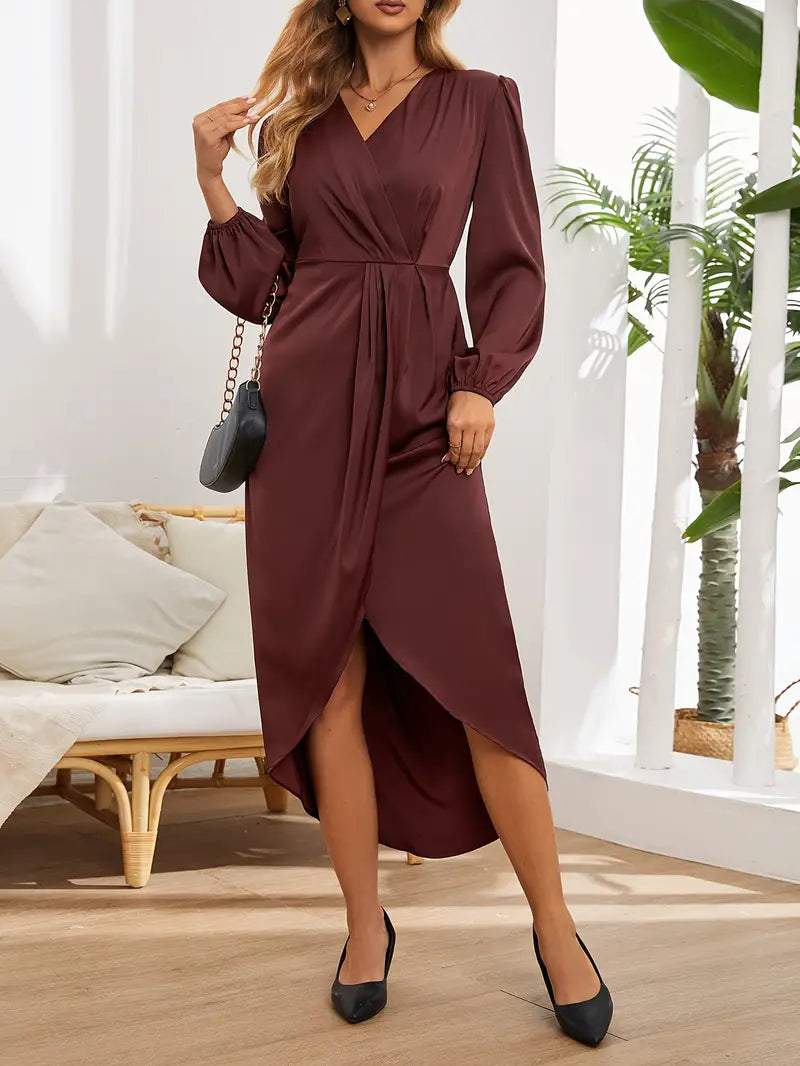 Woman in the Connie draped evening dress with long sleeves and a softly gleaming finish, ready for an elegant night out.