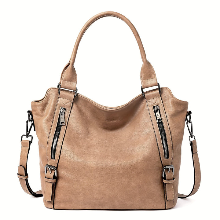 A woman wearing a roomy shoulder bag across her body while out running errands.