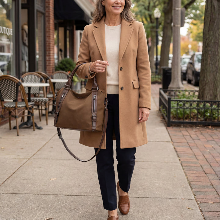 A woman wearing a roomy shoulder bag across her body while out running errands.