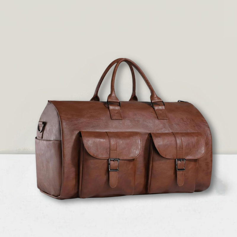 A brown travel holdall with twin top handles and two buckled front pockets resting on a wooden stump.