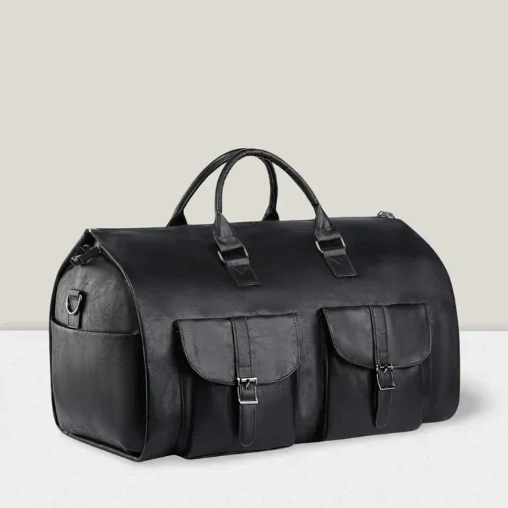 A brown travel holdall with twin top handles and two buckled front pockets resting on a wooden stump.