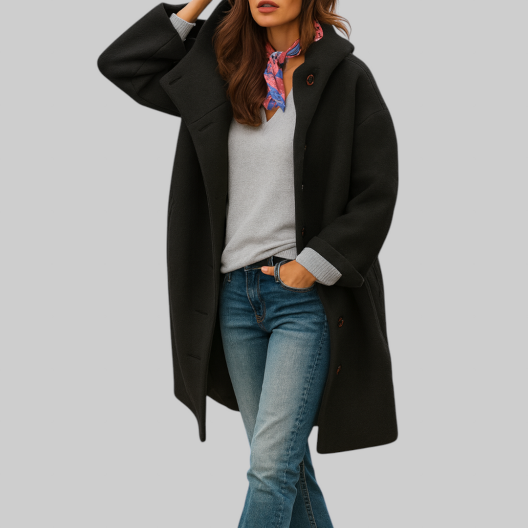 A woman wearing a hooded mid-length coat with wood-look buttons, hands in the side pockets.