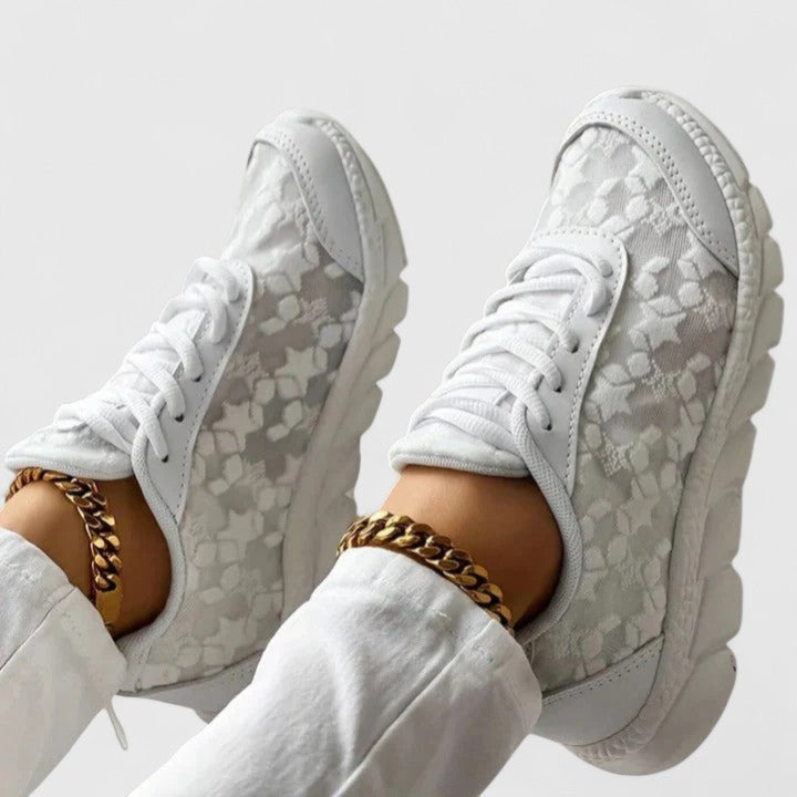 A woman wearing clean white cushioned comfort sneakers