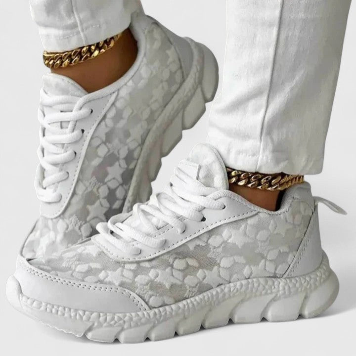 A woman wearing clean white cushioned comfort sneakers