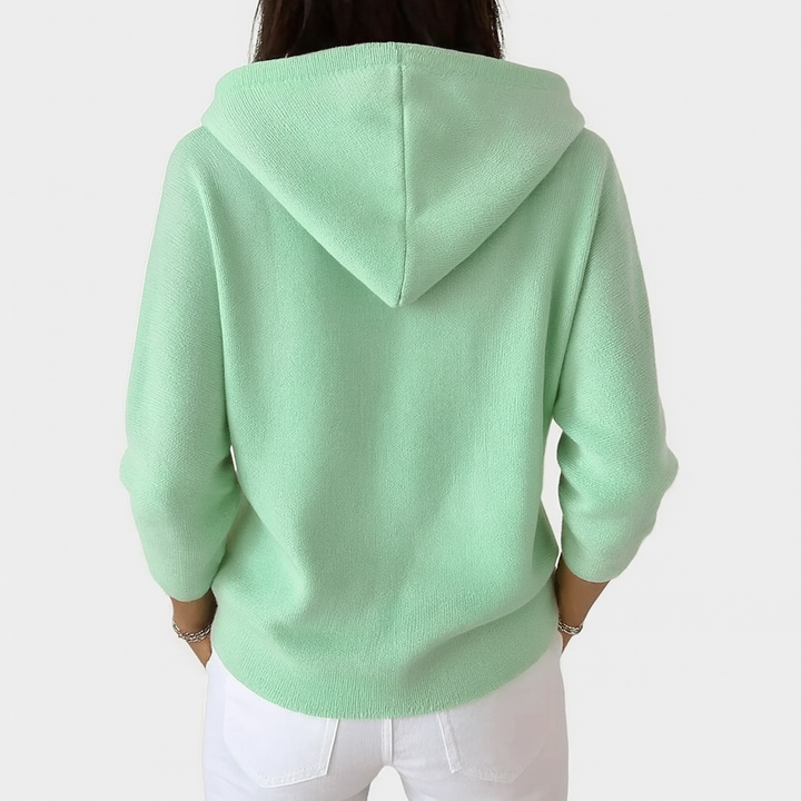 A woman wearing a hooded button cardigan open over a top for a relaxed everyday look.