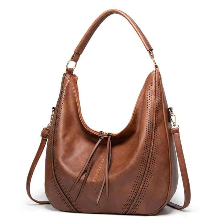 A woman holding a soft grey casual handbag over her shoulder on a relaxed day out.