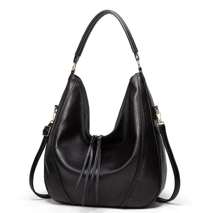 A woman holding a soft grey casual handbag over her shoulder on a relaxed day out.