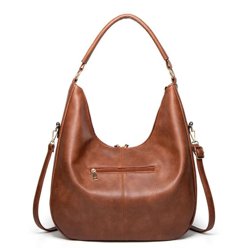 A woman holding a soft grey casual handbag over her shoulder on a relaxed day out.