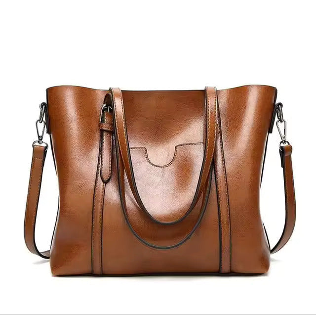 A woman carrying a structured luxe handbag on her arm while out for the day.