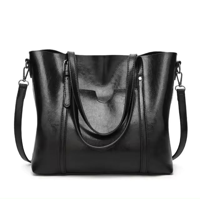 A woman carrying a structured luxe handbag on her arm while out for the day.