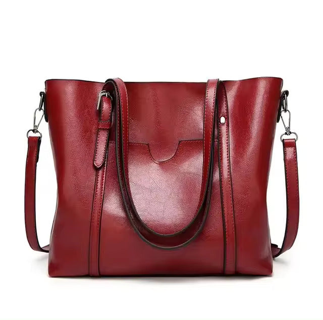 A woman carrying a structured luxe handbag on her arm while out for the day.