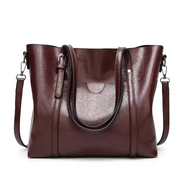 A woman carrying a structured luxe handbag on her arm while out for the day.