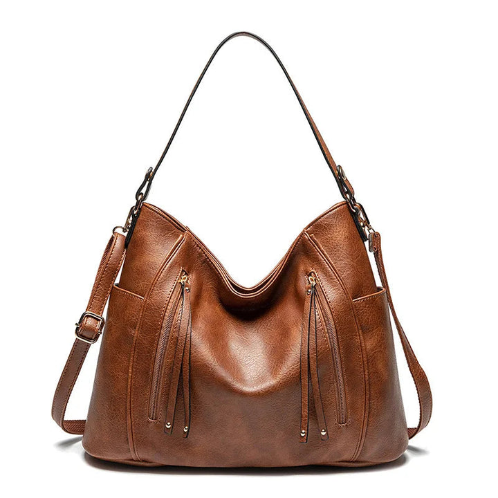 A woman wearing a fringed shoulder bag that sways gently as she walks through town.