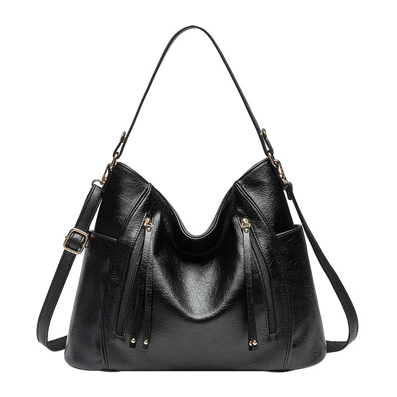 A woman wearing a fringed shoulder bag that sways gently as she walks through town.