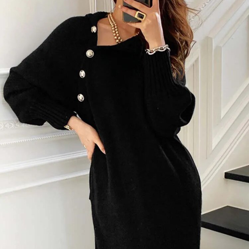 Woman in the Diana cosy wrap dress with gold-tone buttons and a waist tie, holding a warm drink at home.